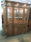 Massive antique style modern hutch cabinet with lighted display and ornate design