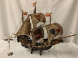 Vintage wooden ship model with various flags on the sails - antique rustic look