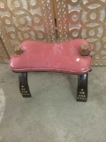 Small red cushioned top vintage camel stool with stud detail