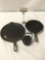 3 vintage cast iron pieces. 2 skillets and a small kettle with a frog and plant design