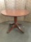 Vintage round top dining table with ornate metal adorned pedestal base with 4 legs