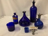 Lot of 6 antique blue glass bottles, decanters, double pour pitcher and glass cube