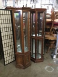 2 tall geometric display cabinet with lighted tops and glass shelves