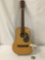 Vintage acoustic guitar with steel reinforced neck and butterfly design, approx 13 x 36 x 4 inches