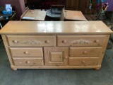 Modern wood dresser with 6 drawers and cabinet, approx 17x64x30 inches. Top shows wear.