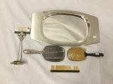 Lot of 3 antique silver plate bathroom pieces and a metal mirror platter. A brush, mirror and comb