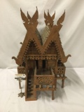 Vintage finely decorated antique Euro style model cabin on stilts with dual roof and wing toppers