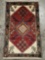 Vintage handmade wool rug with floral design, in red & neutrals - trimmed fringe on one side