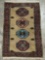 Vintage hand made wool rug with trimmed fringe and geometric designs