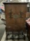 Ornate antique wood carved standing secretary cabinet with hand painted floral detail