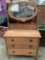 Antique wooden 3 drawer dresser on wheels with attached mirror & wood stud detail