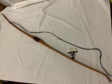 Antique wood hunting bow with leather wrapped grip