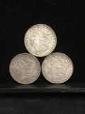 Collection of 3 silver Morgan Dollar coins. The dates included are 1886 1883 and 1887