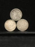 Collection of 3 silver Morgan Dollar coins. The dates included are 1921s 1899o and 1896