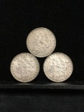 Collection of 3 silver Morgan Dollar coins. The dates included are 1897 1879-O and 1881