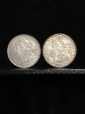 Collection of 2 silver Morgan Dollar coins. The dates included are 1883-O and 1878-S
