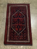 Handmade wool rug with fringe - classic deep red/blue Baluch Iranian style design