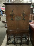 Ornate antique wood carved standing secretary cabinet with hand painted floral detail