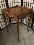 Antique Italian renaissance style wood inlay top end table with ornately carved cherub legs