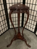 Vintage carved wood plant stand with bowed leg design and lattice side top