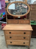 Antique wooden 3 drawer dresser on wheels with attached mirror & wood stud detail