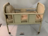 Rare antique metal baby doll crib with bedding and wooden wheels