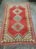 Patterned vintage rug with red hues - classic Iran design, in good condition