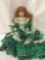 Large MBI porcelain doll with flowing green dress. The doll measures approximately 28x16x9 inches.