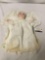 Vintage porcelain Baby doll with pillow signed c400. Measures approximately 14x13x2 inches.