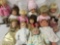 Twelve vinyl, composite, and porcelain dolls from makers like Battat, Pat Secrest, Heritage Mint,