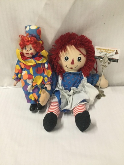 Raggedy Ann doll and vintage porcelain clown doll. Raggedy Ann measures approximately 16x14x4