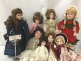 Eight porcelain and composite dolls from makers like Brinns. Largest doll measures approximately