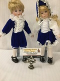 Pair of porcelain dolls designed by Marian Yu. Larger doll measures approximately 12.5x8x3 inches.