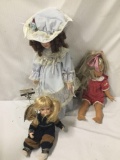 3x porcelain and vinyl dolls. Collectible memories and more. Largest doll measures approximately
