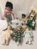 Six porcelain dolls from makers like Tuss, Royal Courts, and Geppeddo. Largest doll approx. 9x21x4.5