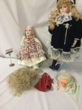 Two porcelain dolls, one by Victoria Ashley and the other by Solyei. Lot includes a wig, hat, two