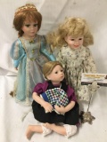 3x Porcelain and composite dolls. Largest doll measures approximately 16x7x4 inches.