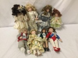 Collection of 8 porcelain and composite dolls. Largest doll measures approximately 17x8x4