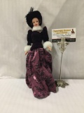 Modern Mattel Barbie in purple dress with hat. Measures approximately 12x5x2 inches.