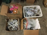 Open box lot. 4 boxes of doll stands and doll clothes hangers. Largest box measures approximately