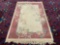 Vintage floral wool rug with fringe and pink border