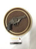 Antique revolver mounted on a wall plate