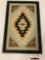 Framed needlepoint woven artwork, approximately 16 x 25 inches.