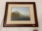 Framed photograph of ocean scene with coastal cliffs, approx 24x20 inches.