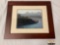 Framed photograph of penguins on the beach with mountains in the background, approximately 25 x 21