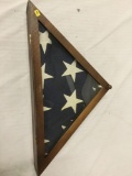 Vintage folded United States flag in case. Case is beginning to come apart at the seem.