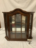 Vintage carved wood display case with mirror back and glass window doors, approx 28x7x27 inches