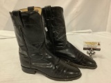 A pair of Justin?s Black leather cowboy boots, made in USA style 3/33, has tear in leather,