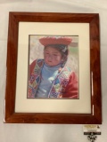 Framed photograph of Peruvian girl in regional attire, approximately 20 x 24 inches.