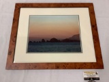 Framed photograph of coastal sunset, approximately 23 x 19 inches.